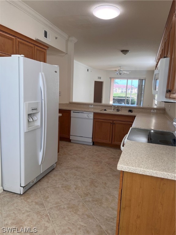 8470 Kingbird Loop, Unit 1020 Estero, FL 33967 - Photo 6 of 17 a kitchen with stainless steel appliances granite countertop a refrigerator a stove and a sink