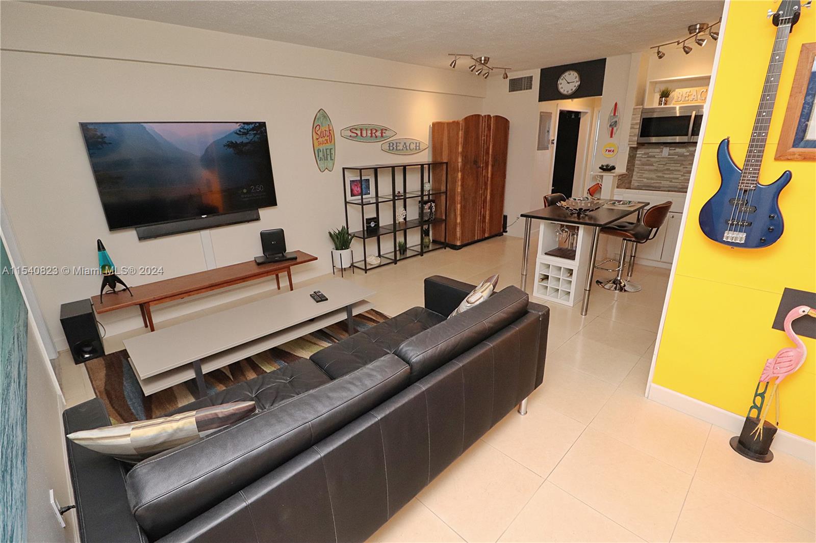 1801 South Surf Road, Unit 2E Hollywood, FL 33019 - Photo 5 of 24 a living room with furniture and a flat screen tv