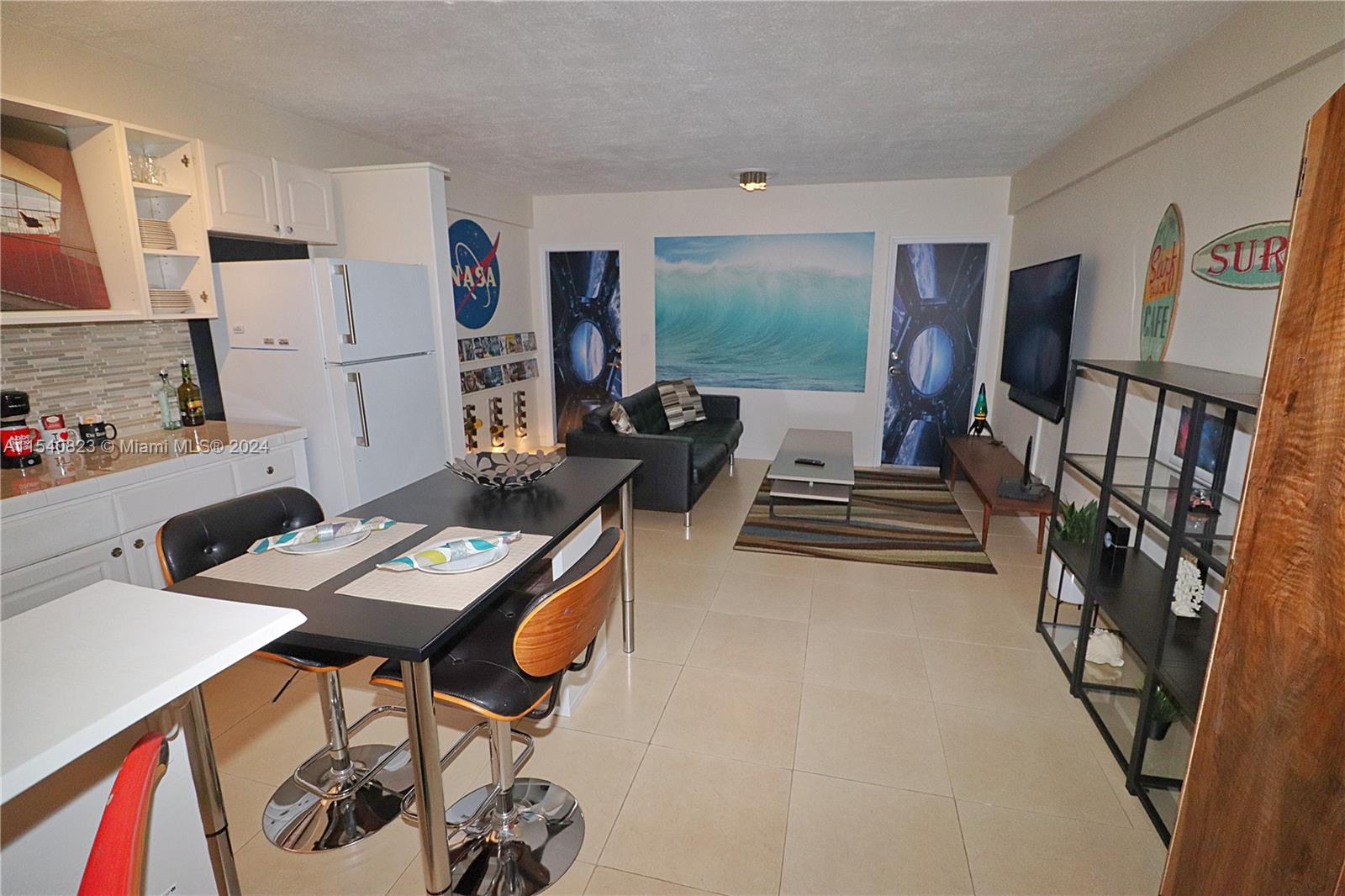 1801 South Surf Road, Unit 2E Hollywood, FL 33019 - Photo 6 of 24 a living room with furniture and a flat screen tv