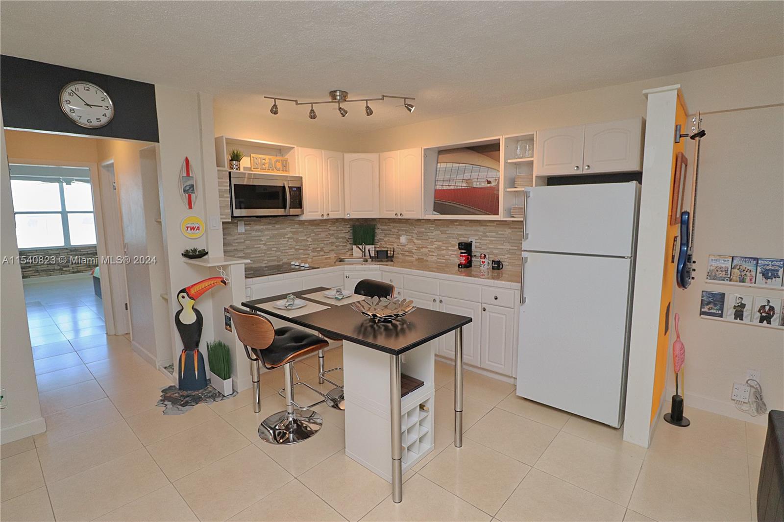 1801 South Surf Road, Unit 2E Hollywood, FL 33019 - Photo 7 of 24 a kitchen with stainless steel appliances granite countertop a sink refrigerator and microwave