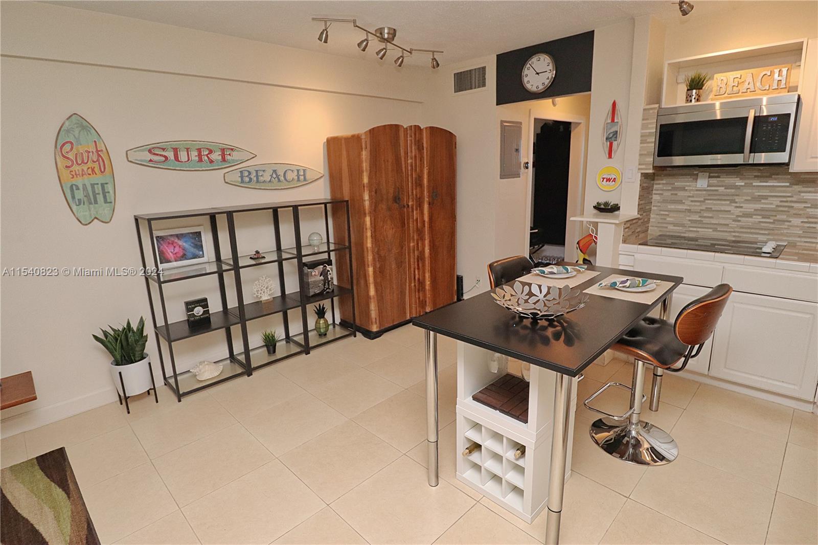 1801 South Surf Road, Unit 2E Hollywood, FL 33019 - Photo 9 of 24 a view of a furniture in kitchen and an empty room