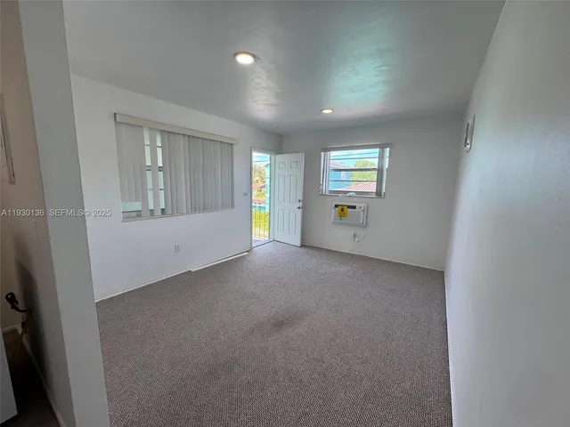 an empty room with windows and entrance