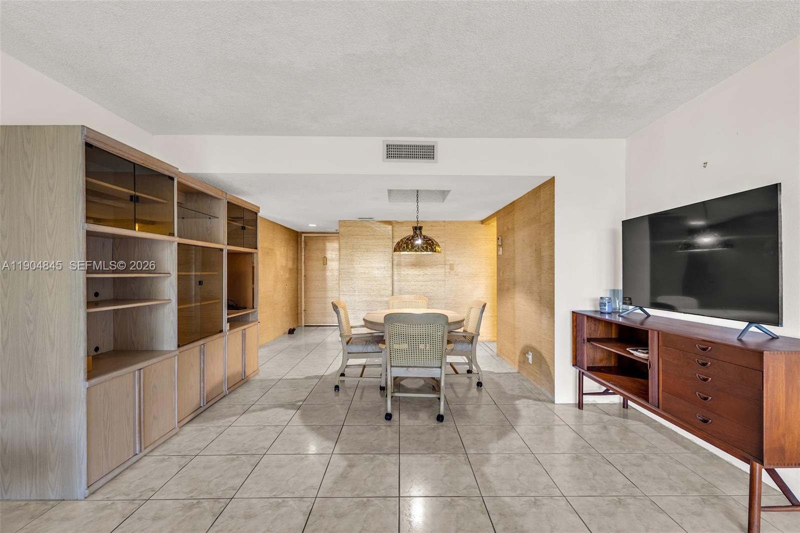 16300 Golf Club Road, Unit 408 Weston, FL 33326 - Photo 14 of 31 a living room with furniture and a flat screen tv