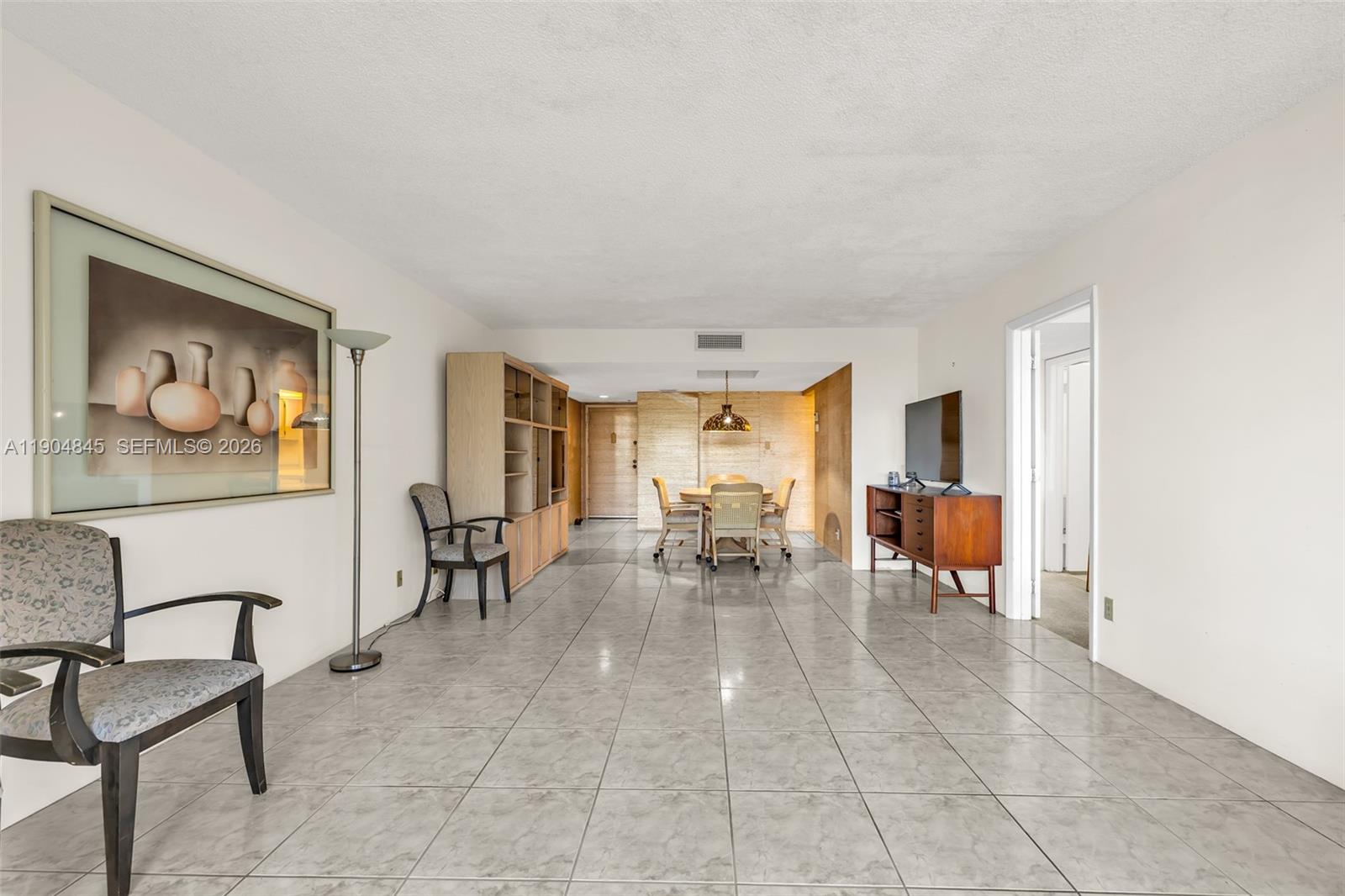 16300 Golf Club Road, Unit 408 Weston, FL 33326 - Photo 19 of 31 a living room with furniture and a dining table