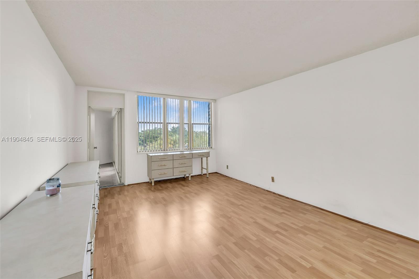 16300 Golf Club Road, Unit 408 Weston, FL 33326 - Photo 24 of 31 an empty room with wooden floor and windows