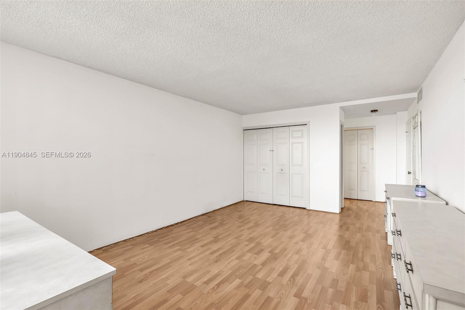 16300 Golf Club Road, Unit 408 Weston, FL 33326 - Photo 25 of 31 a view of an empty room with wooden floor