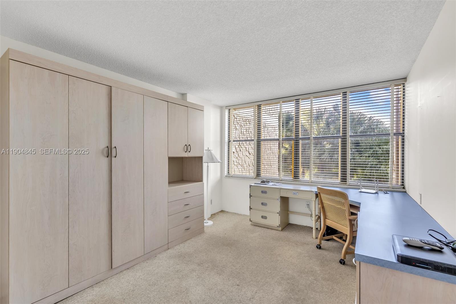 16300 Golf Club Road, Unit 408 Weston, FL 33326 - Photo 28 of 31 a view of a livingroom with workspace and a window