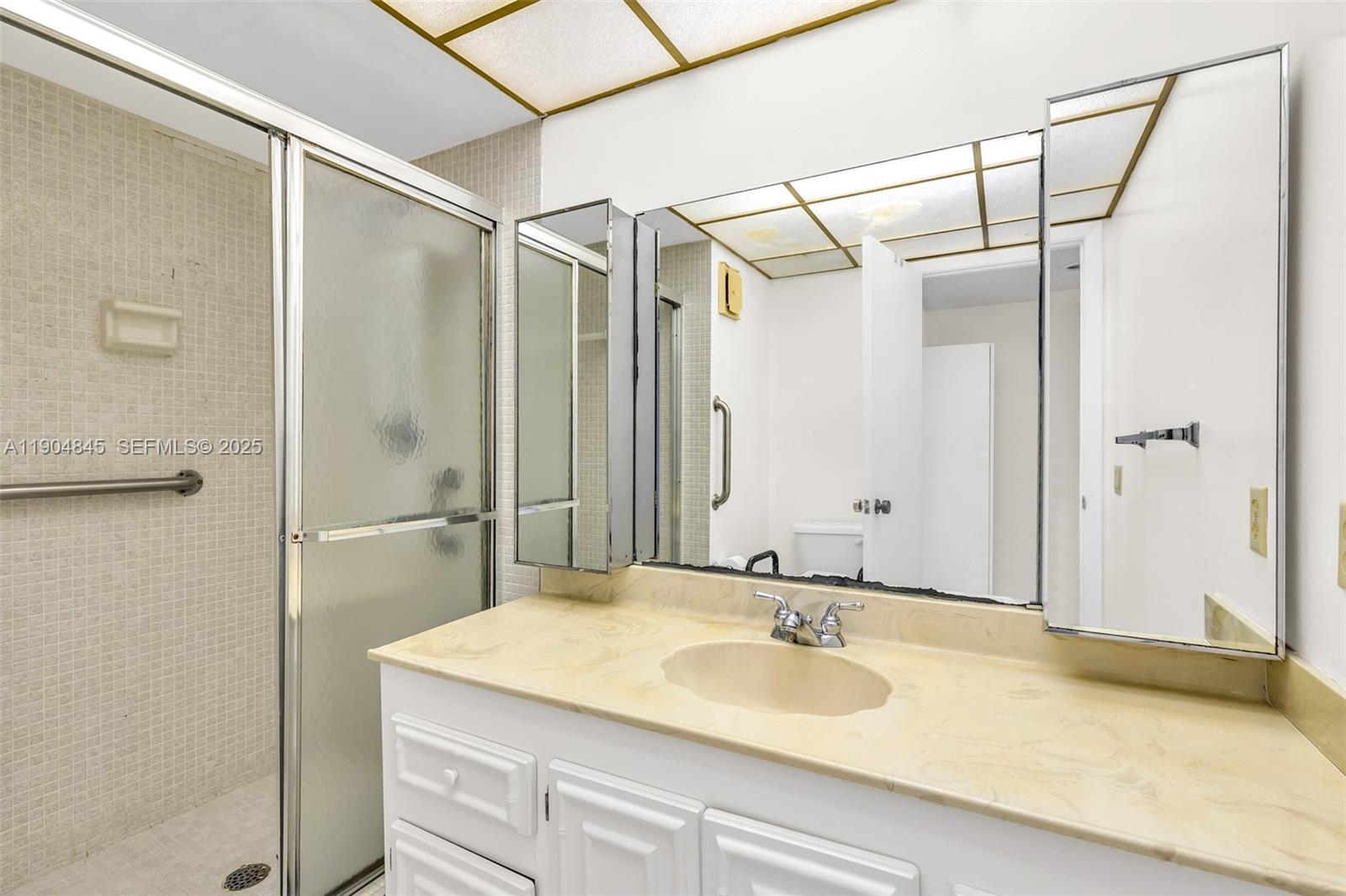 16300 Golf Club Road, Unit 408 Weston, FL 33326 - Photo 30 of 31 a bathroom with a sink and a mirror