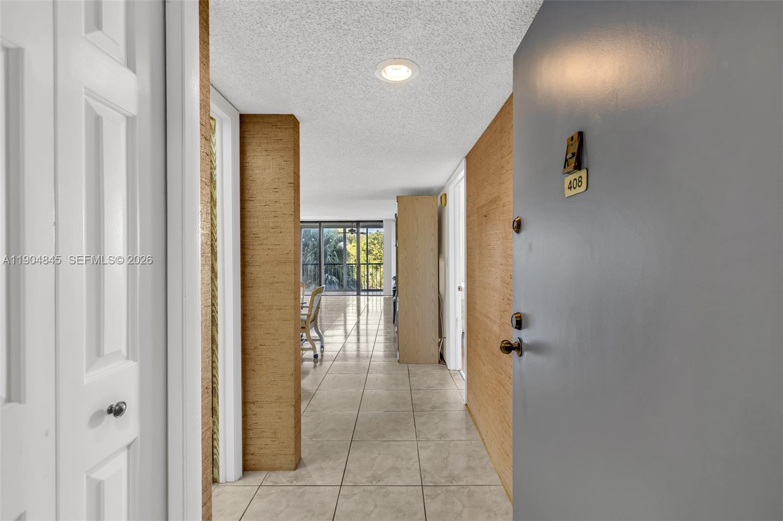 16300 Golf Club Road, Unit 408 Weston, FL 33326 - Photo 10 of 31 a view of a hallway with windows and closet