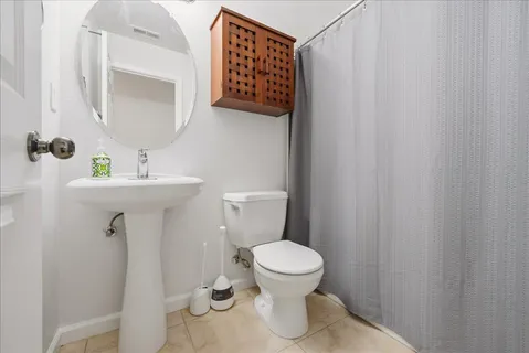 a bathroom with a sink toilet and mirror