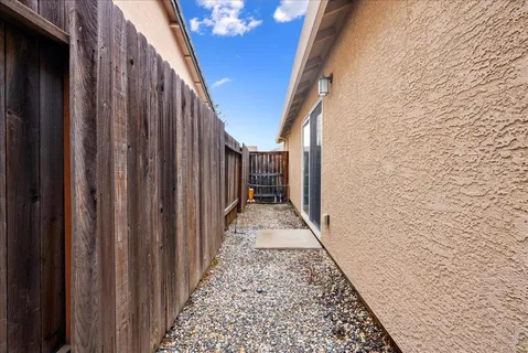 a view of a pathway of a house with wooden walls