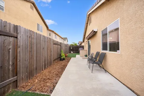 a backyard of a house with outdoor seating