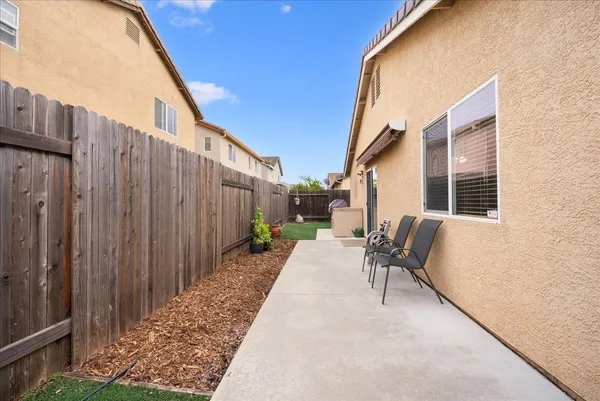 a backyard of a house with outdoor seating