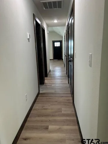 a view of gallery with wooden floor