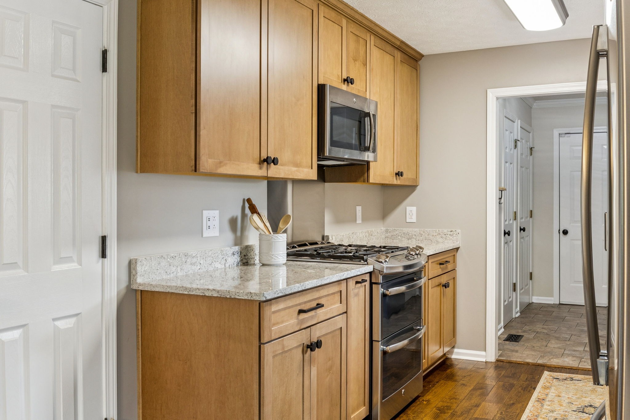 6683 East Benton Road Springfield, TN 37172 - Photo 20 of 64 a kitchen with stainless steel appliances granite countertop a stove a sink and a granite counter tops