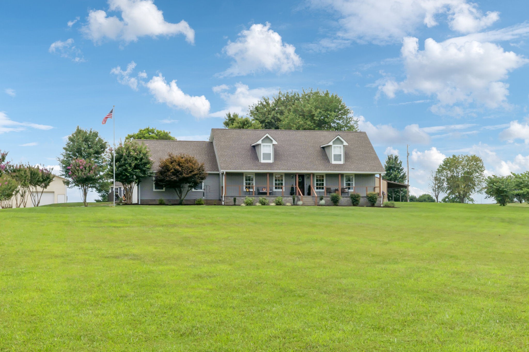 6683 East Benton Road Springfield, TN 37172 - Photo 2 of 64 a view of a house with a big yard and large trees