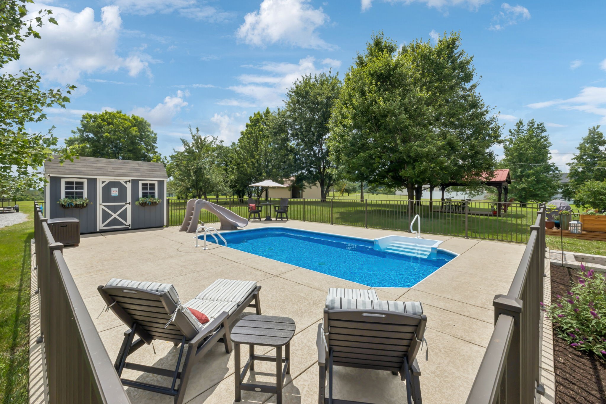 6683 East Benton Road Springfield, TN 37172 - Photo 41 of 64 a view of a swimming pool with a lounge chair