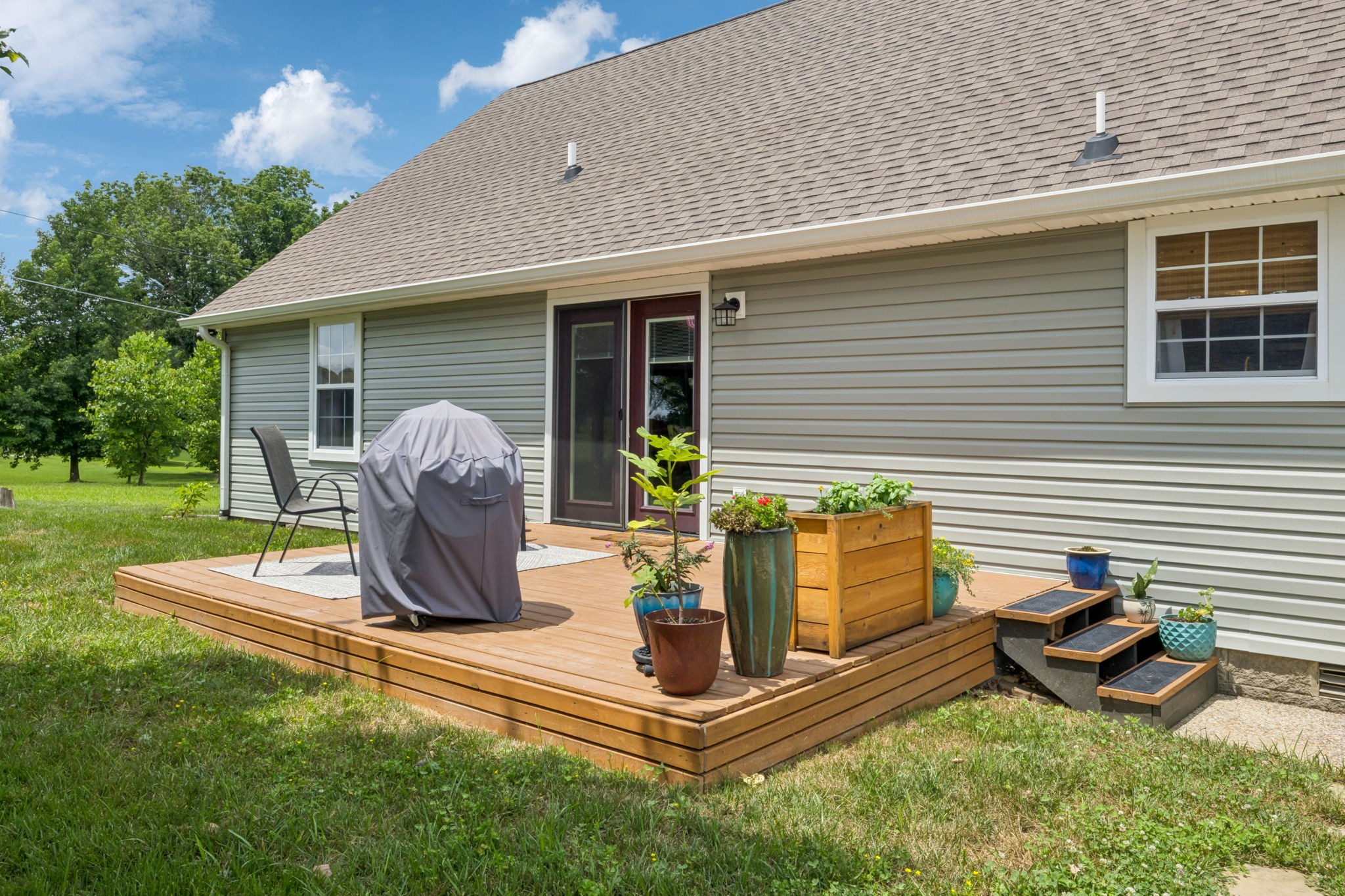 6683 East Benton Road Springfield, TN 37172 - Photo 46 of 64 a view of a patio with table and chairs potted plants and a large tree