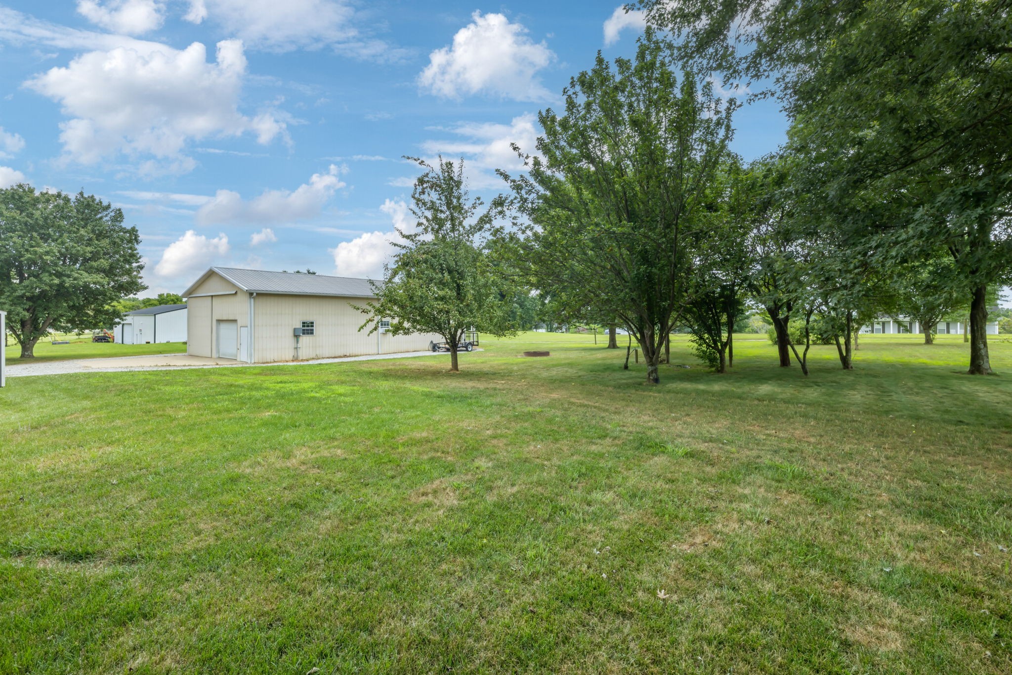 6683 East Benton Road Springfield, TN 37172 - Photo 58 of 64 a view of a house with a big yard and large trees