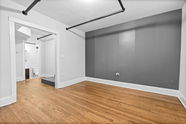 a view of an empty room with wooden floor