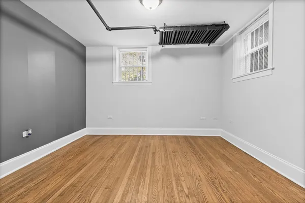 a view of a room with wooden floor and a window