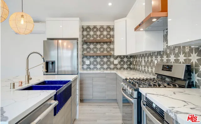 a kitchen with a sink and a stove top oven