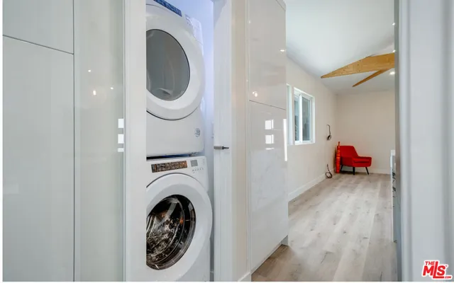 a view of a hallway with washer and dryer