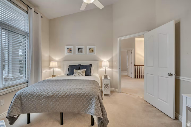 11789 Nicklaus Road Sandy, UT 84092 - Photo 27 of 58 Bedroom with light colored carpet, vaulted ceiling, and a ceiling fan