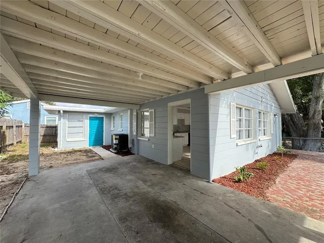 a view of a house with backyard porch and roof