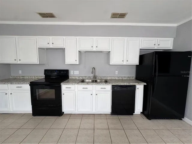 a kitchen with a refrigerator and a stove