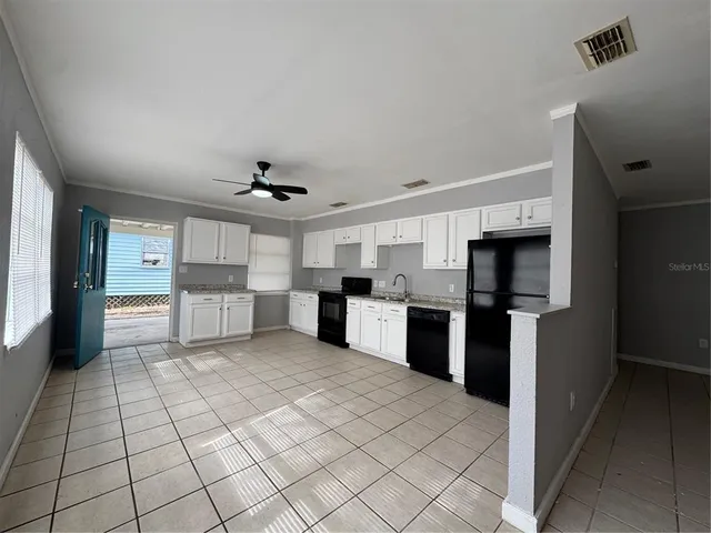 a view of a kitchen with microwave and refrigerator