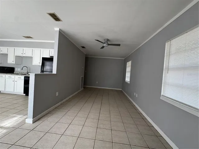 a view of a livingroom with wooden floor and staircase