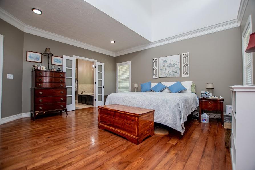 575 Liberty Church Road Carrollton, GA 30116 - Photo 22 of 95 a spacious bedroom with a bed and wooden floor