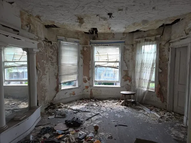 a view of wooden floor and a window in an empty room