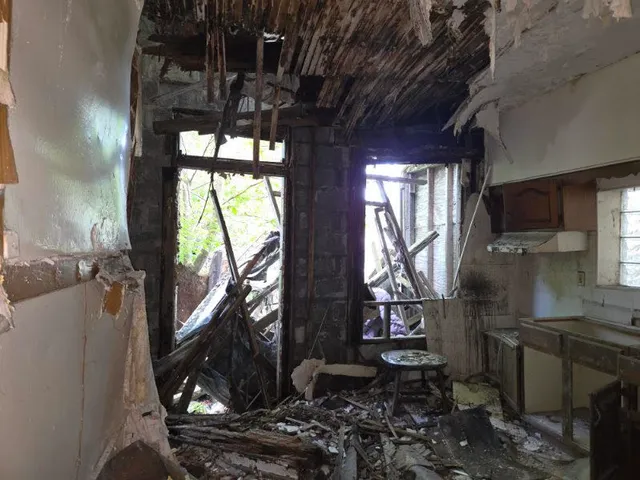 a kitchen with lots of white cabinets and a sink