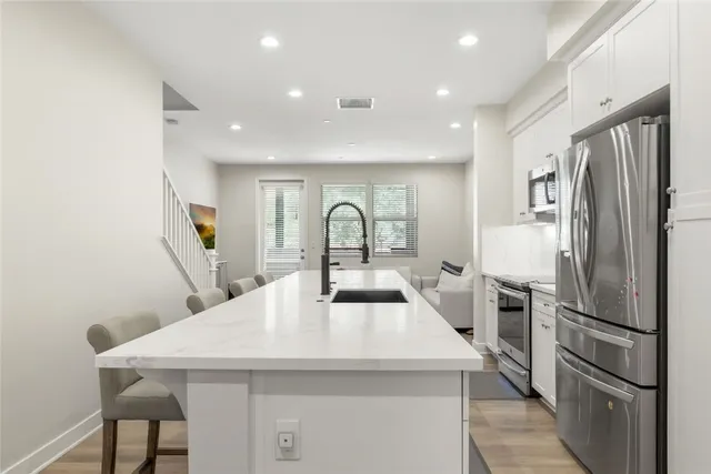 a kitchen with refrigerator a sink and cabinets