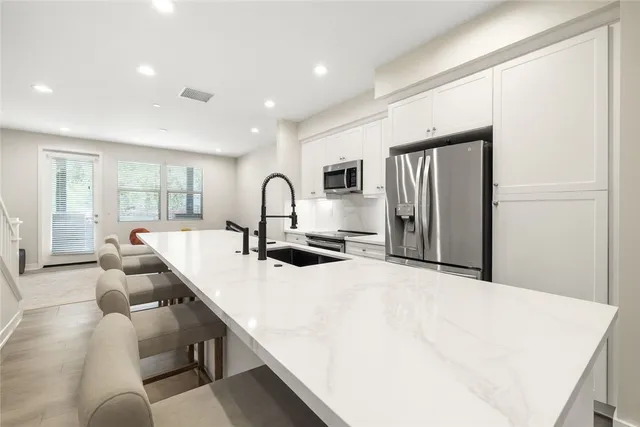 a large white kitchen with a large window