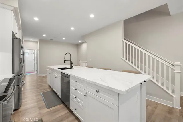 a kitchen with sink and mirror