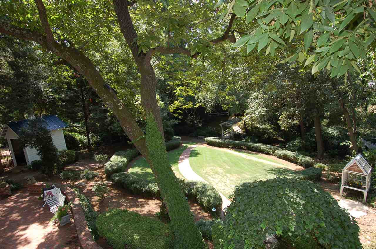 1913 Lewis Circle Raleigh, NC 27608 - Photo 5 of 30 Beautiful Park Like Setting Includes Potting Shed, Walkways, Wandering Creek, Covered Bridge Beautiful Park Like Setting