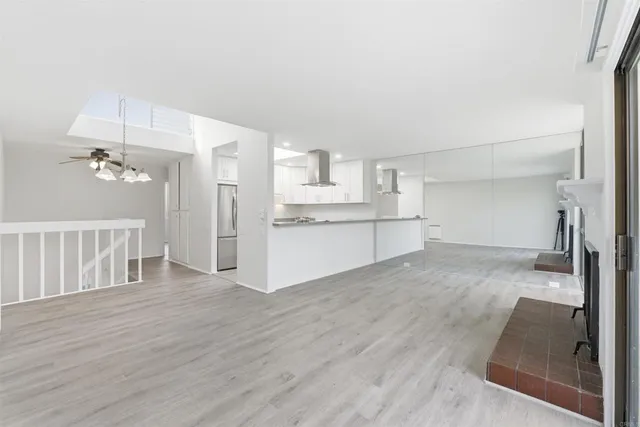 a view of a kitchen with a sink and dishwasher cabinets with wooden floor