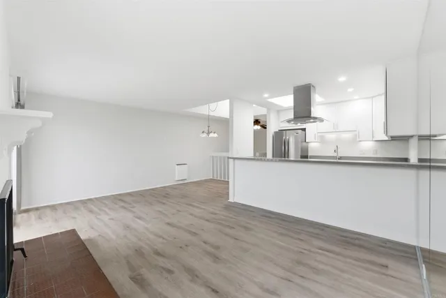 a kitchen with kitchen island a counter top a stove and a wooden floors