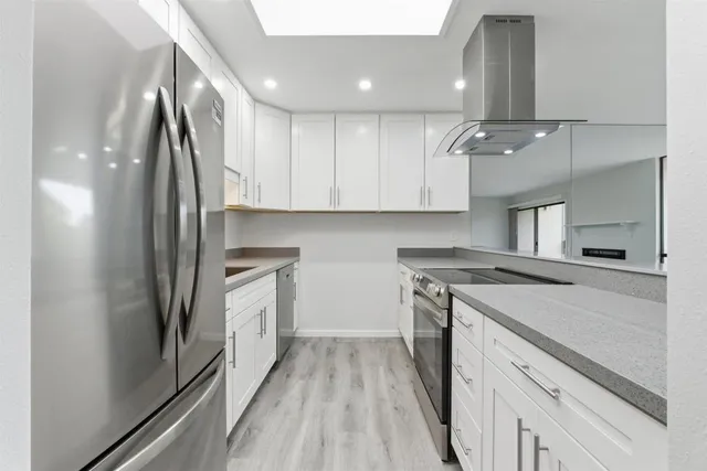 a kitchen with a sink stove and refrigerator