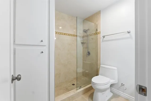 a bathroom with a shower a toilet and a sink