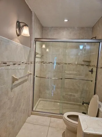 a bathroom with a sink toilet and a mirror