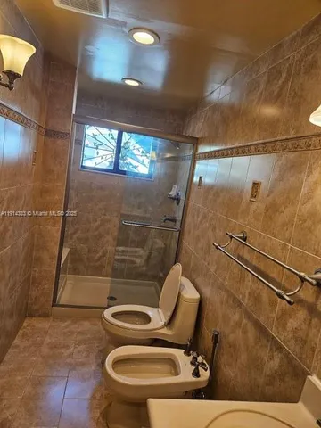 a view of a backyard with table and chairs under an umbrella