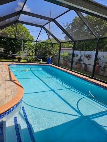 a view of swimming pool with outdoor seating