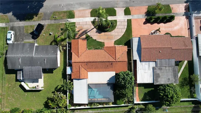 an aerial view of residential house with outdoor space and swimming pool