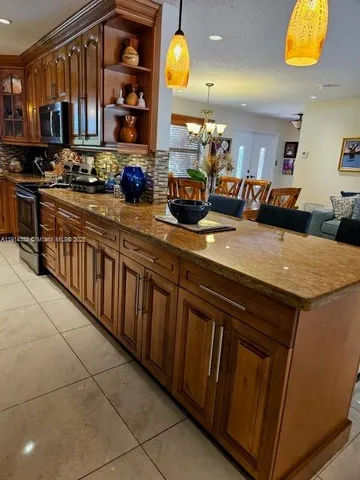 a kitchen with stainless steel appliances granite countertop a sink and cabinets