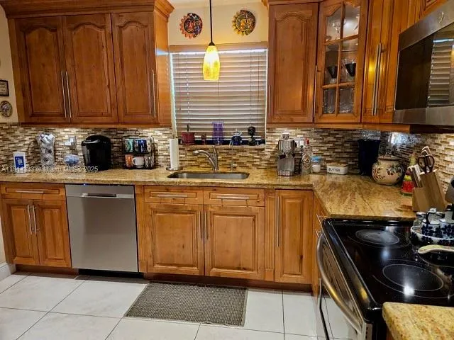 a kitchen with stainless steel appliances granite countertop a sink and cabinets