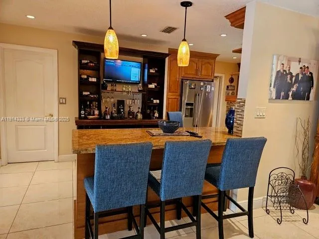 a kitchen with a sink a stove and a refrigerator